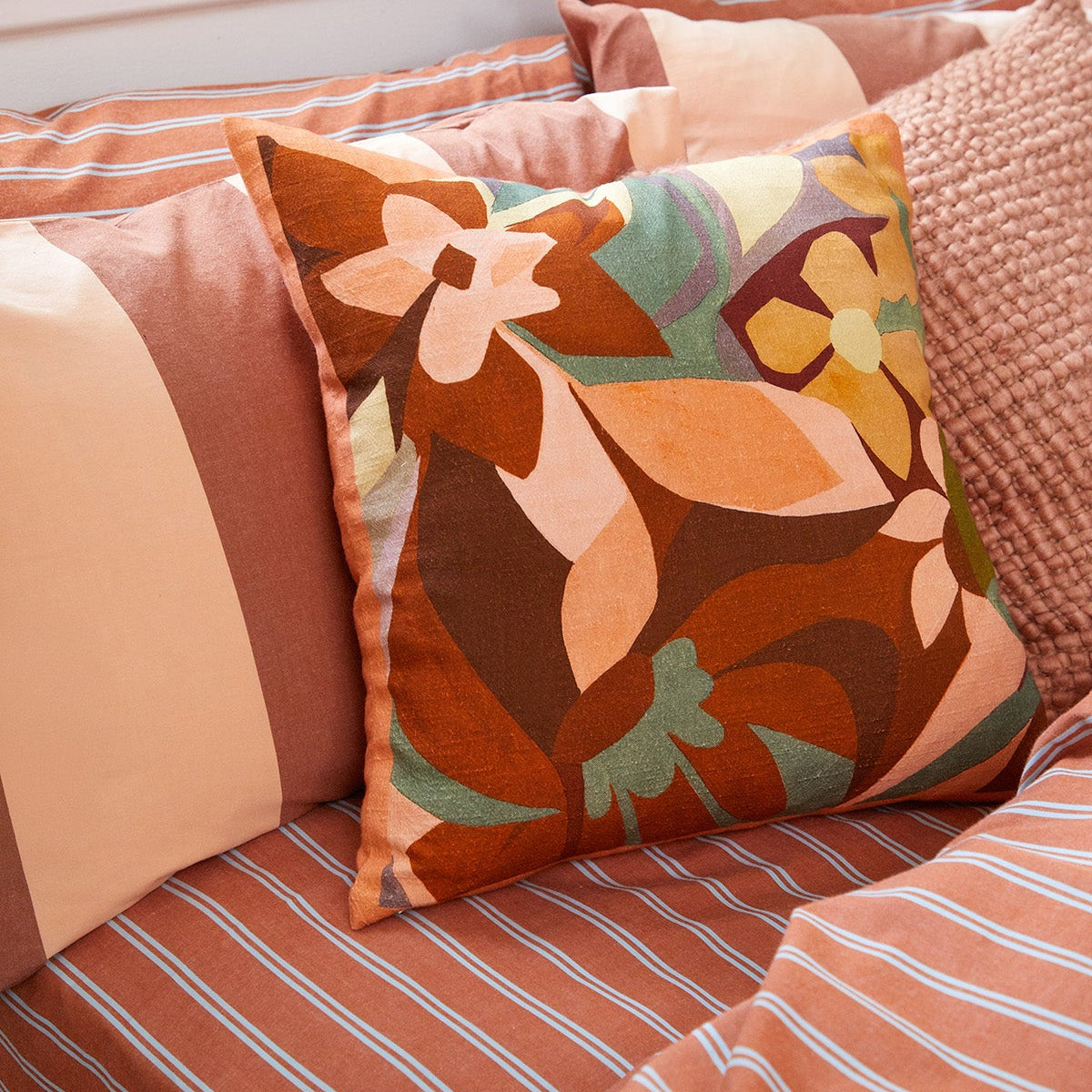 Breeze Rust Quilt Cover Set, rust-colored stripes on a bed