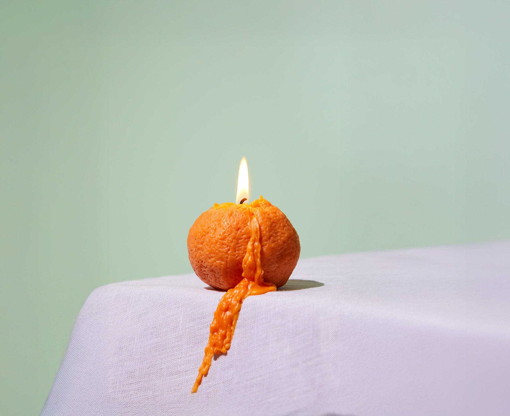 Naval Orange Large Candle, frontal view of a bold, orange candle in a playful shape