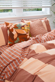 Breeze Rust Quilt Cover Set, rust-colored stripes on a bed