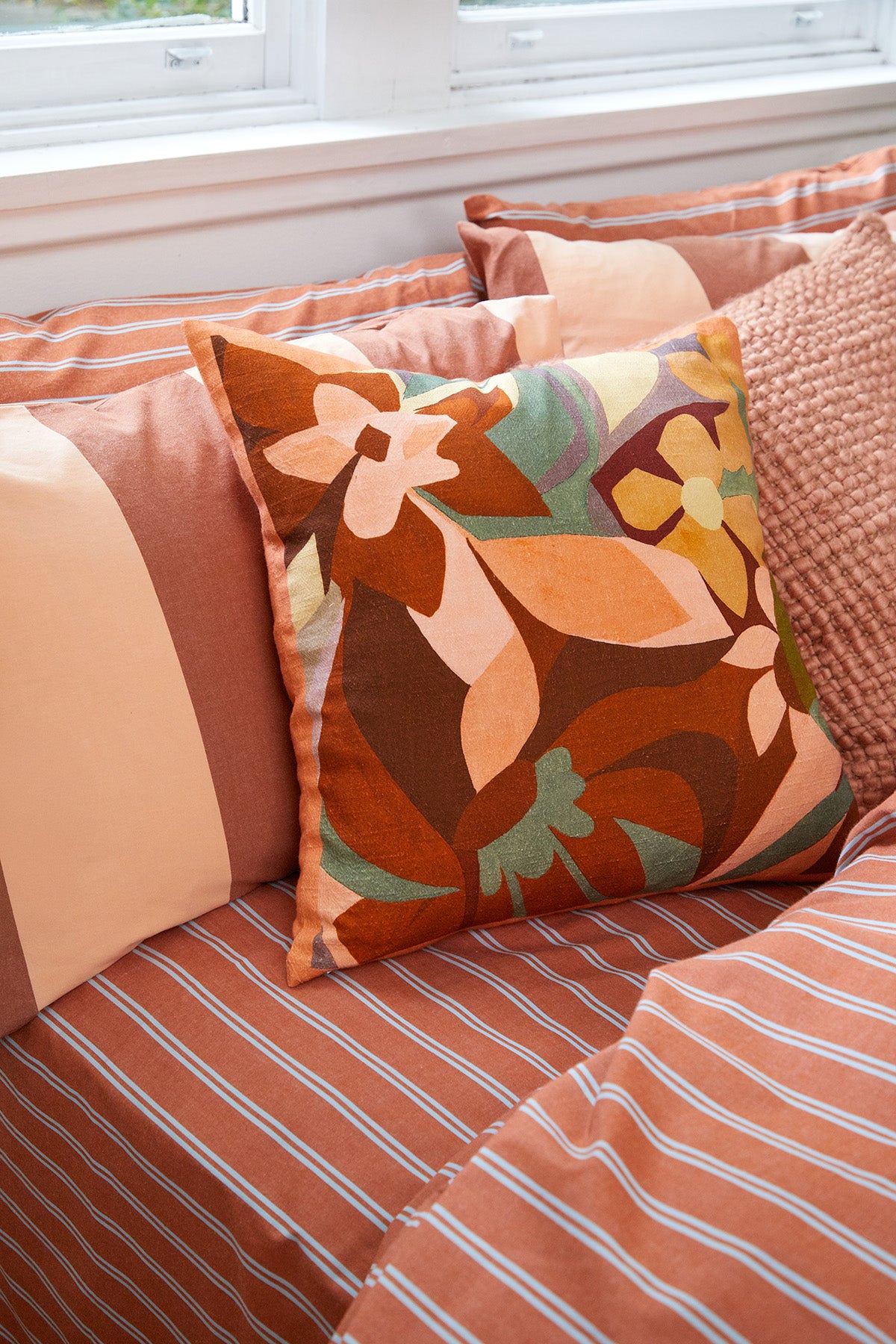 Breeze Rust Quilt Cover Set, rust-colored stripes on a bed