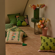 Drake Cushion in lifestyle setting, neutral color, with flat piping detail and velvet reverse.