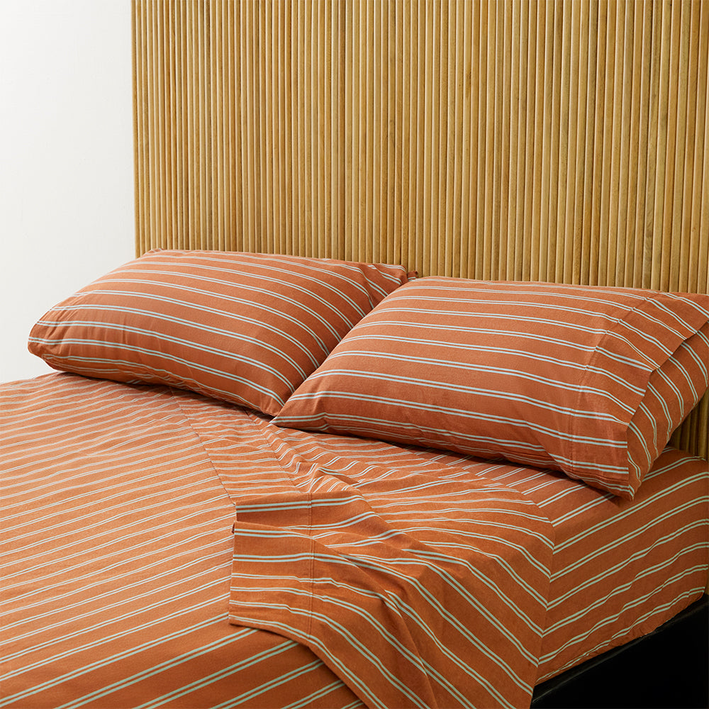 Pinstripe Rust Sheet Set, folded with subtle stripes visible